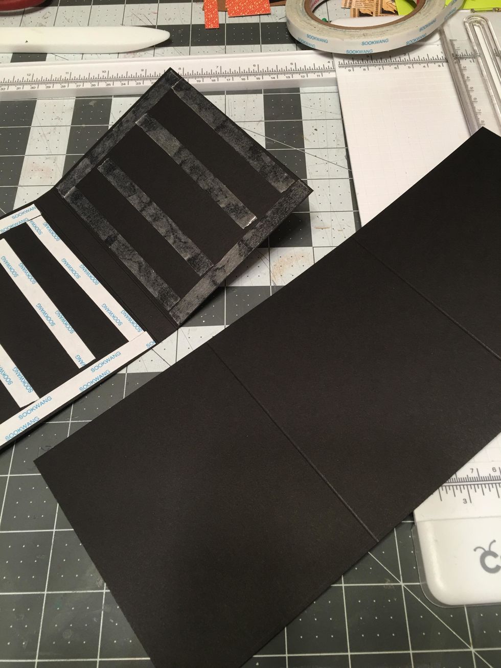 Peel the tape backing off of ONE side of the hinge piece.