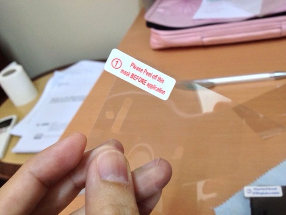 Peel the top part of the screen guard (number 1)