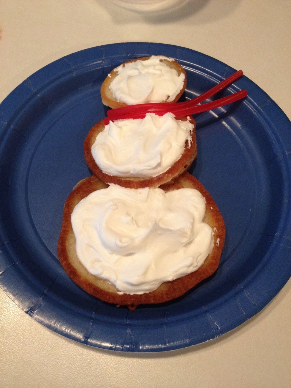 Peel two sections of the Twizzler and arrange to make the snowman's scarf. (Cut the Twizzler if it's too long.)