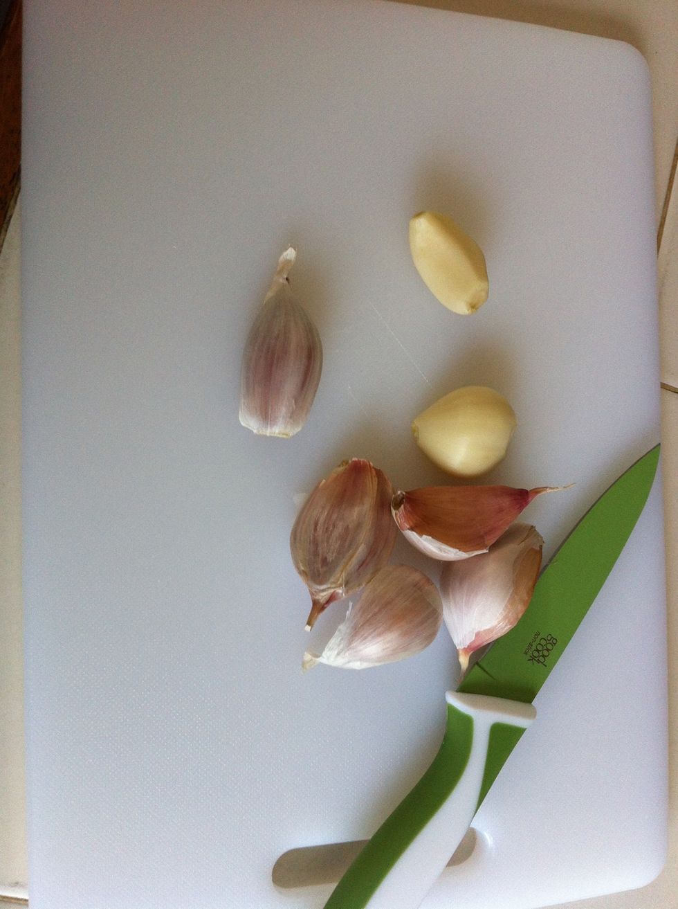Peel your entire garlic bulb. Dice up all but two cloves and add to the water