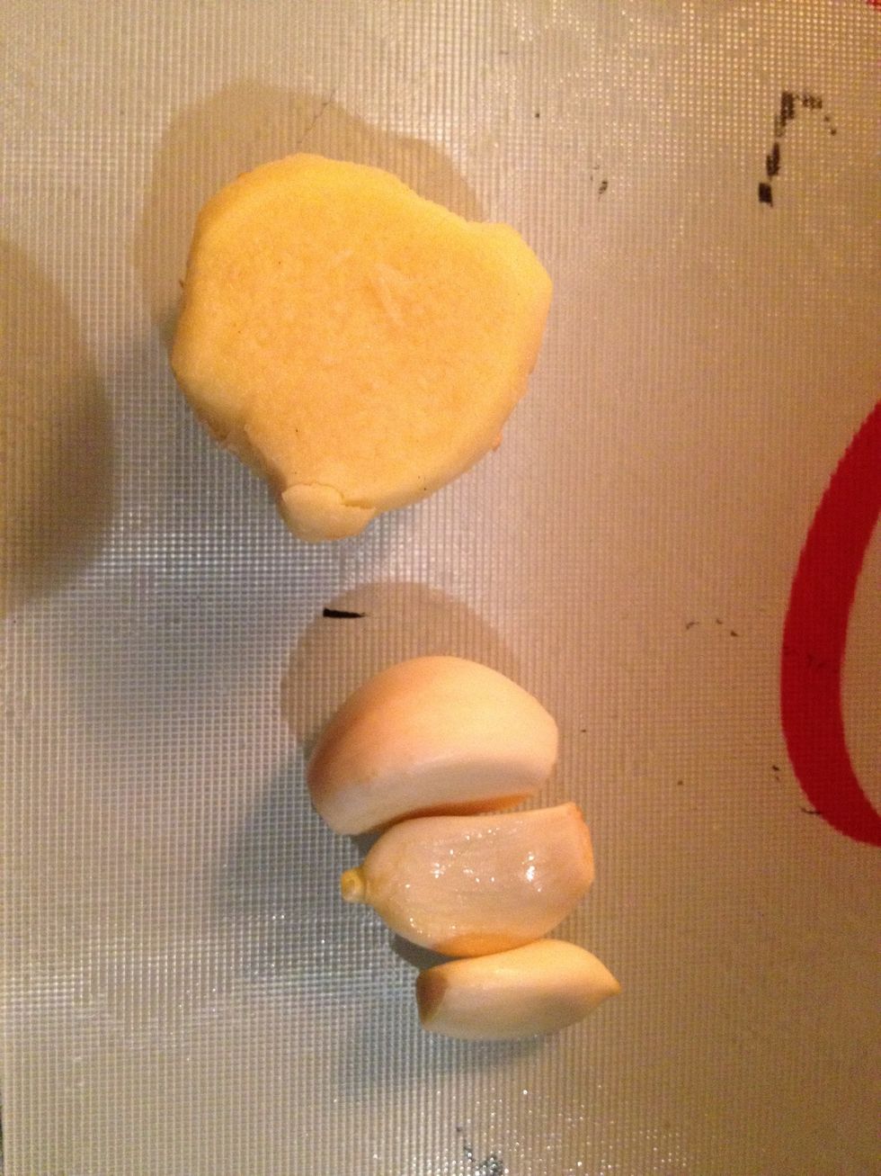Peel your ginger ready for grating. Peel your garlic ready for crushing.