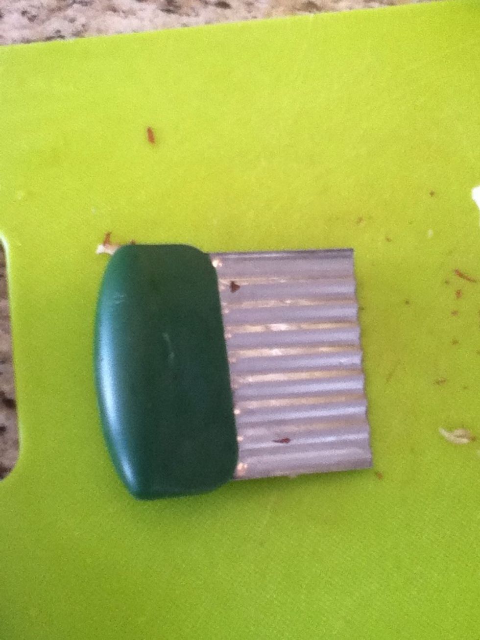 Peel your potatoes leaving bits and pieces left of the potato. Now begin to slice your potatoes about a quarter of an inch thick. I used this handy tool but you can simply cut them with a knife.