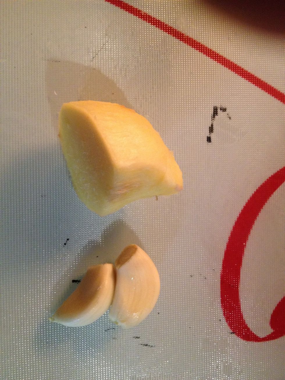 Peel your root ginger, ready for grating. Peel your garlic, ready for crushing.