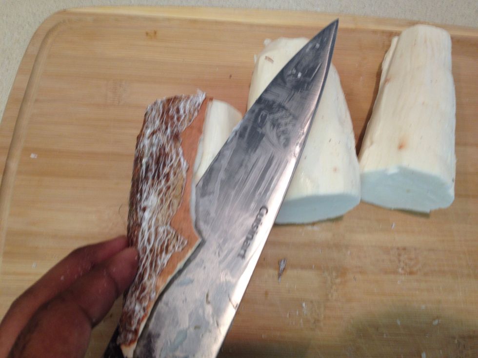 Peeling the yuca just slide your knife on the wax yuca skin and peel