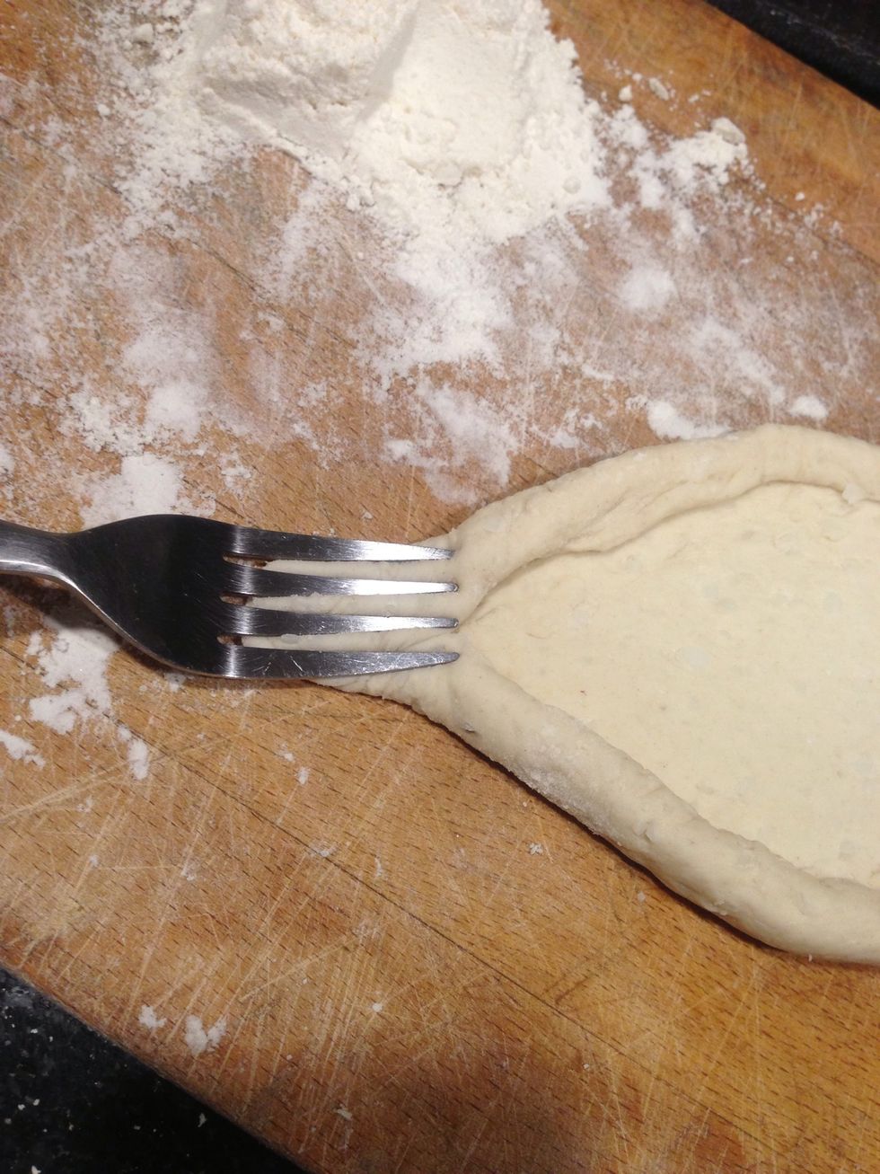 Peirce the tips if each side with a fork