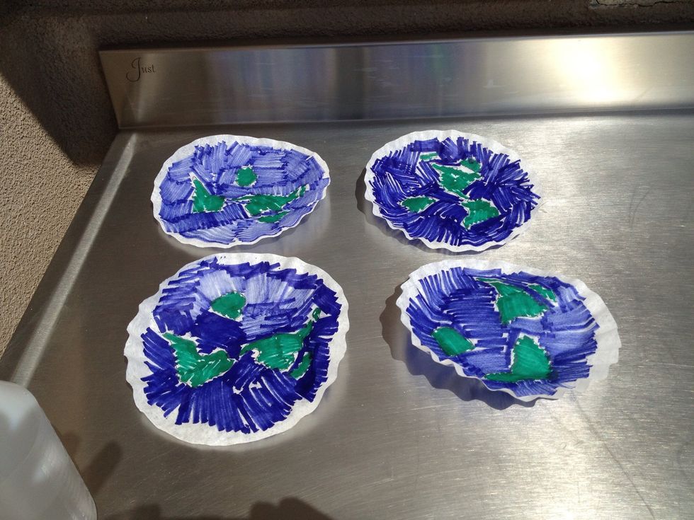 Pencil in the continents and color them with a green washable marker. Color the oceans with a blue washable marker. Don't worry about white spaces.