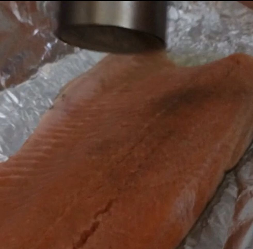 Pepper and salt your Salmon to season it.