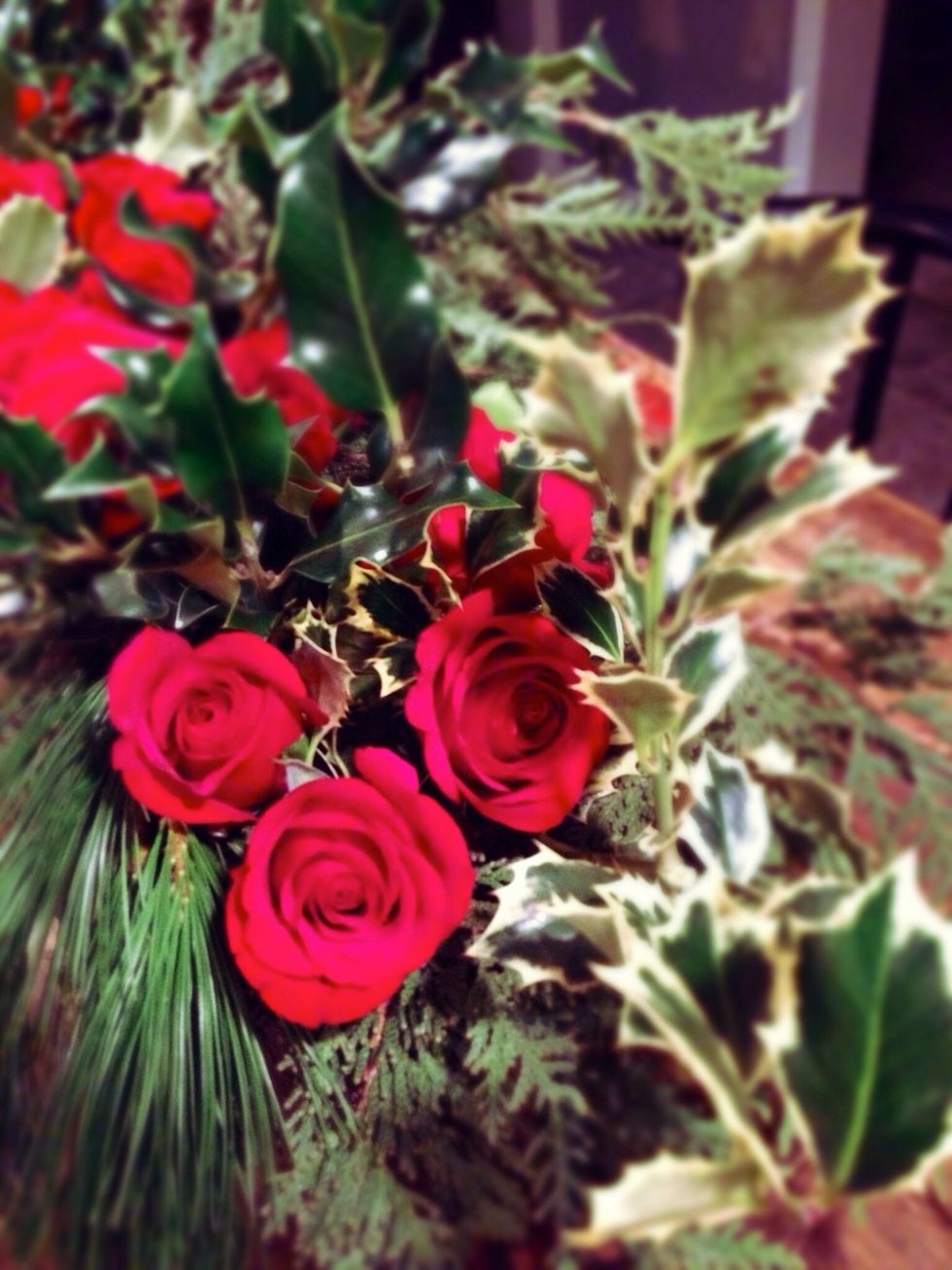 Personally, we like to place the roses throughout the arrangement in small bunches. If we were to space them all evenly, it could start to look like a funeral spray.