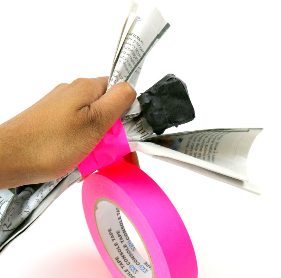 Pick a different color of tape to wrap around the torso, or middle part, of your figurine.