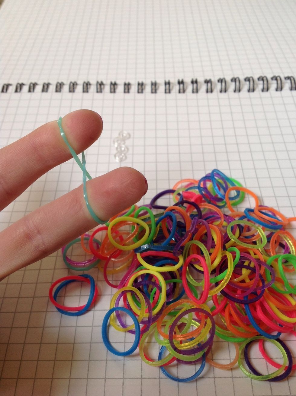 Pick out 1 band and twist around your pointy and middle finger.