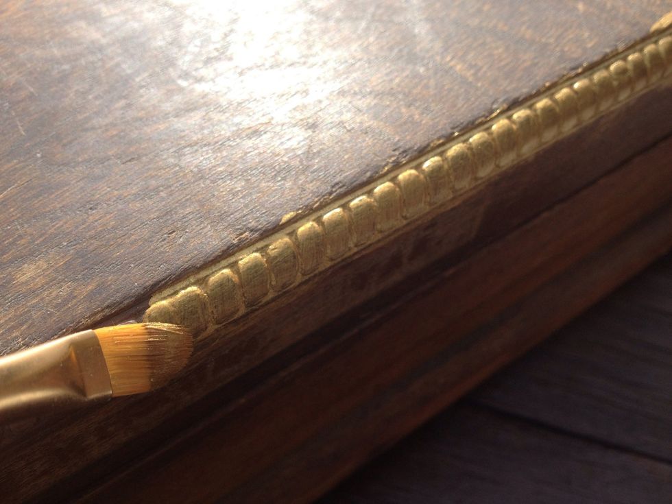 Pick out parts that you like and paint them a bright color to show them off, that goes well with your paper. I particularly like gold. Also run some paint around the edges where your paper won't cover