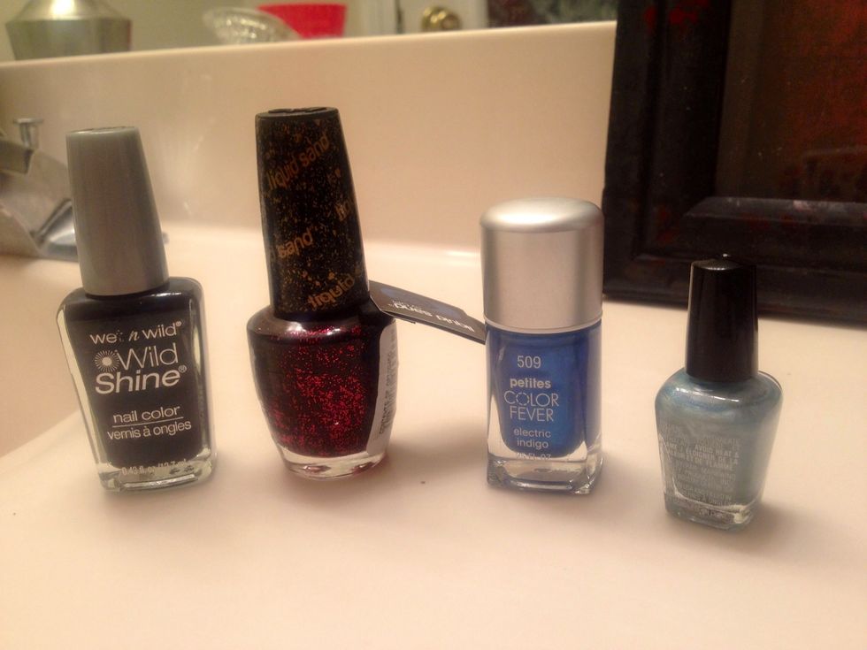 Pick out your polish. For this particular style I used a dark base: dark green, a red glitter, and a couple lighter color blues for the tips.