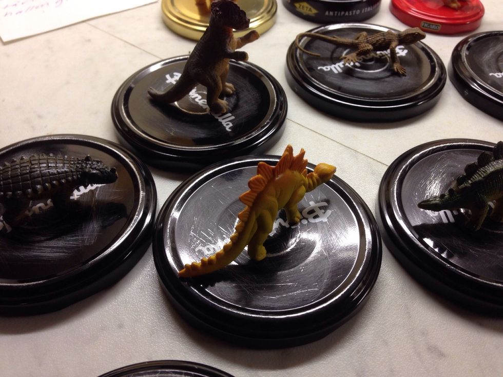 Pick suitable plastic animals, they can't be bigger than the lid.