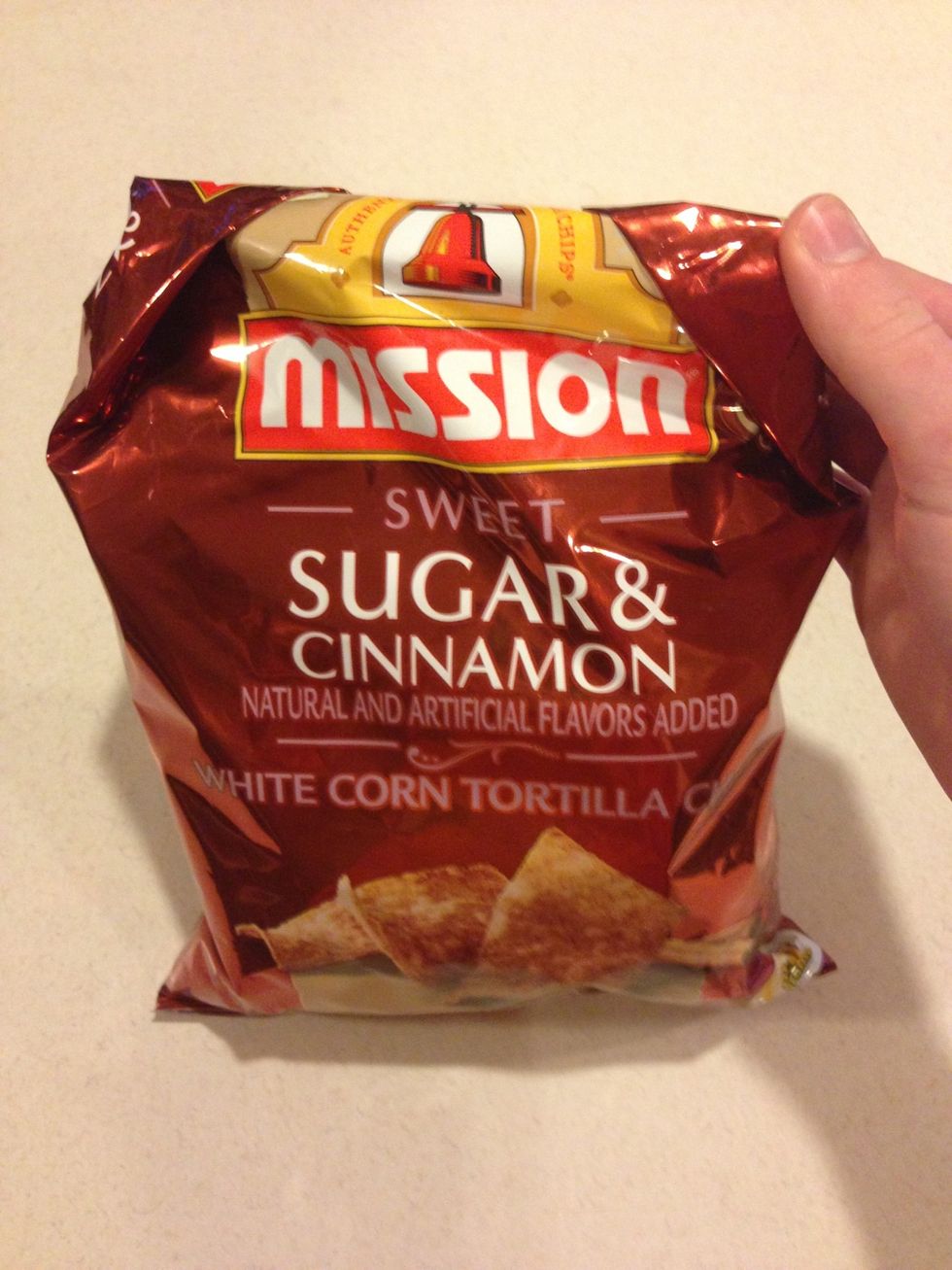 Pick the bag up so you are viewing the front of it again, keeping it rolled tightly.