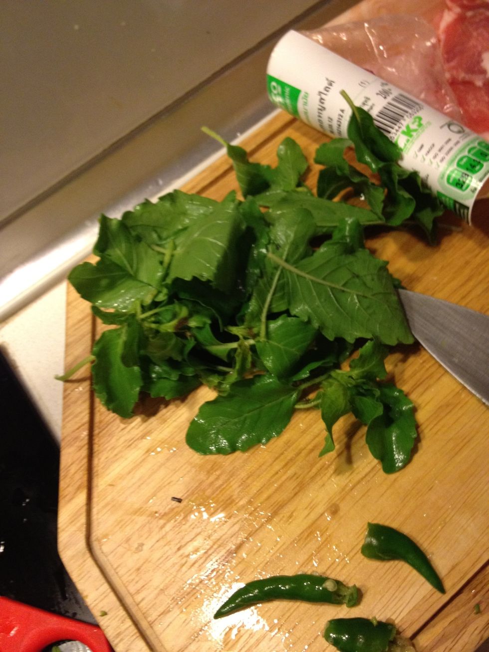 Pick the holy basil leaves. Only use the leaves and the flowers. Discard the stems
