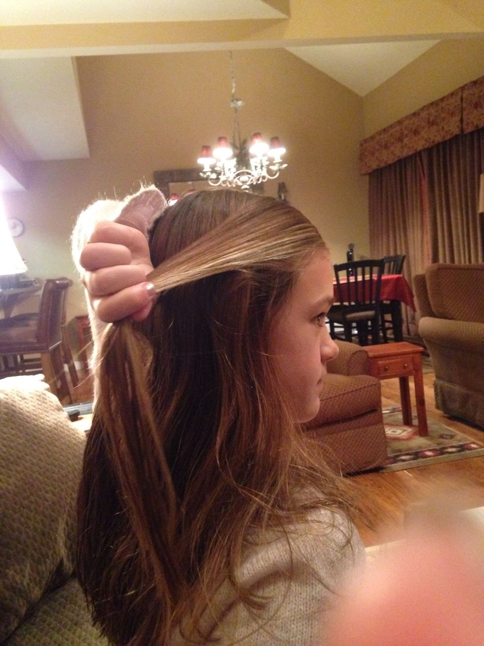 Pick up a small section from the top of your hair like shown in the picture