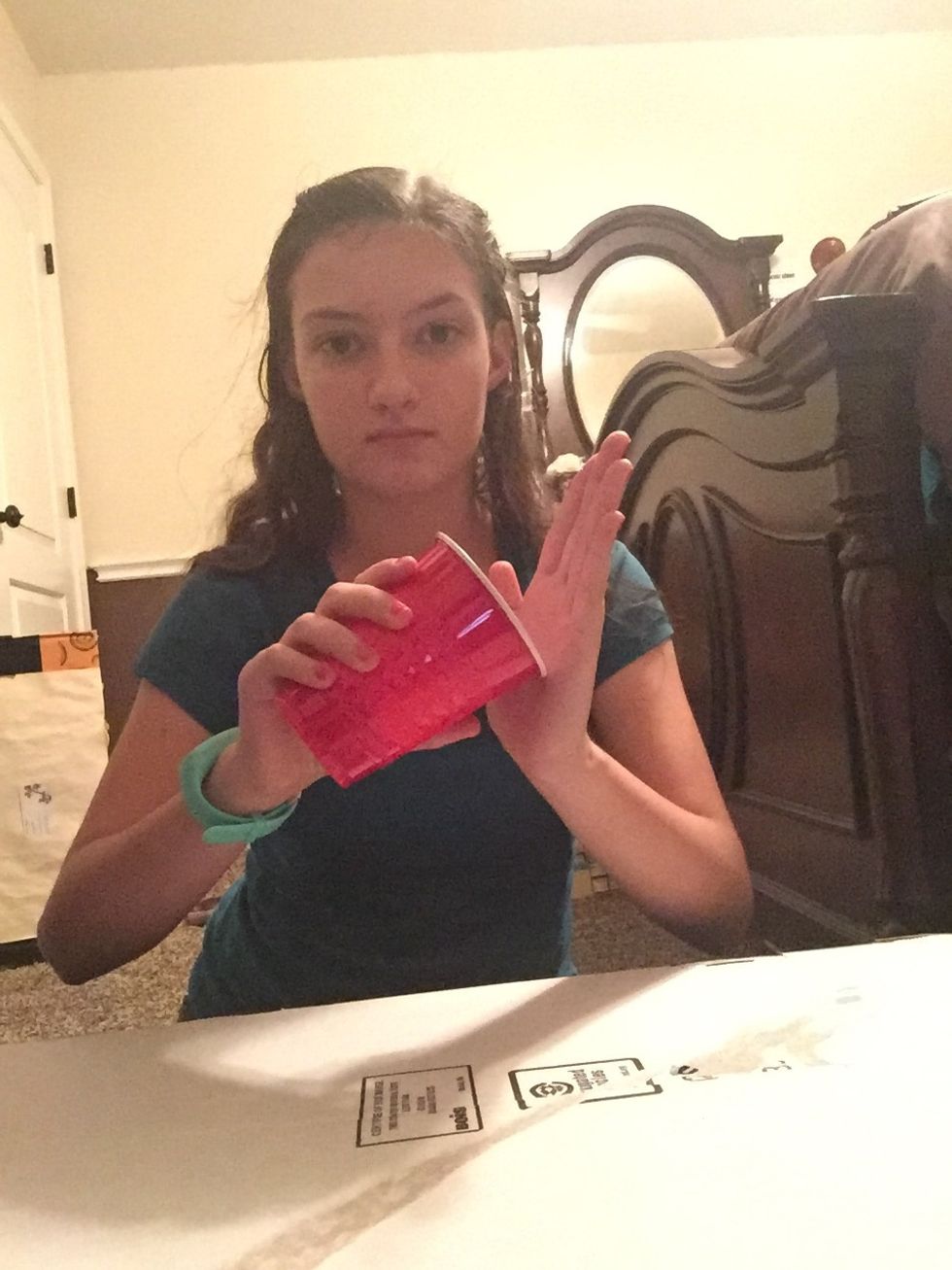 Pick up the cup and hit the bottom against your left palm.