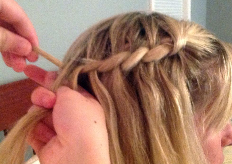 Pick up the first two strands along with another piece of hair.