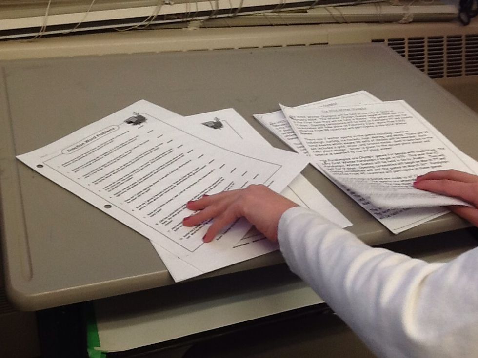 Pick up the morning math practice and reading practice from the grey desk.