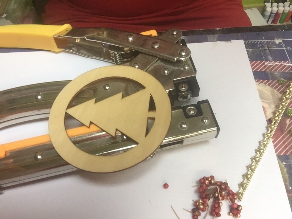 Pierce a hole in your wooden circle to hang the ornament later