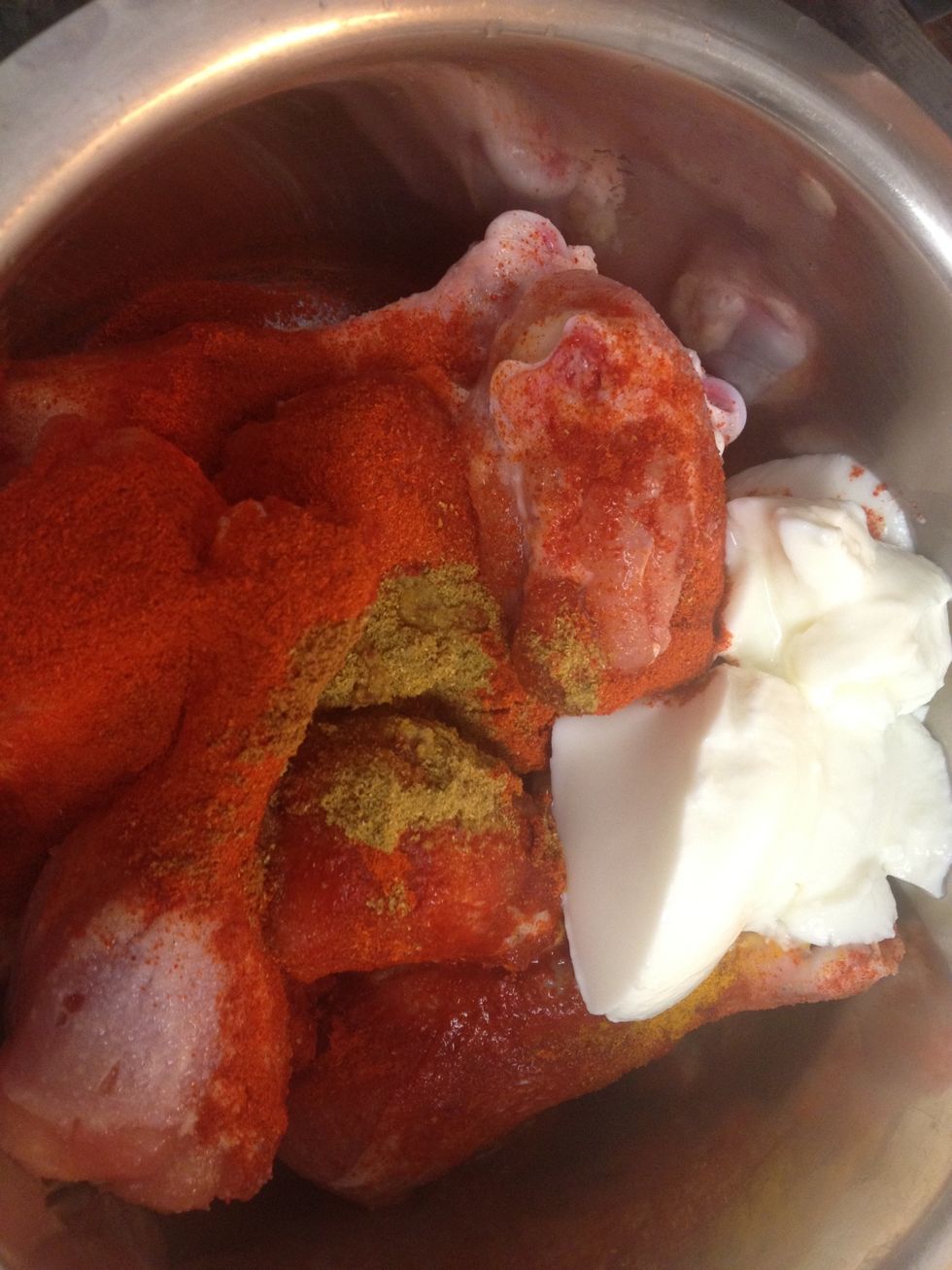 Pierce chicken with a knife or fork and make small cuts so the marinade goes into the meat. Add Yogurt, ginger garlic paste, salt, turmeric, red chili powder, lime juice, coriander and cumin powder.