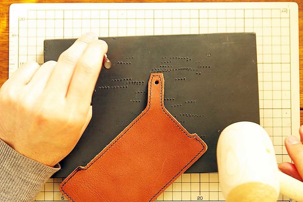 Pierce it with a hammer for buttonhole.
