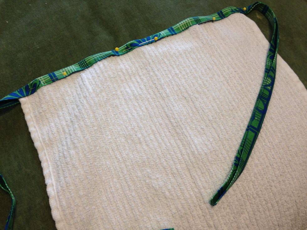 Pin bias tape to one edge of washcloth (centering bias tape to center of washcloth). Sew along the edge to attach the binding. You could do this by hand, but....a sewing machine is much easier.