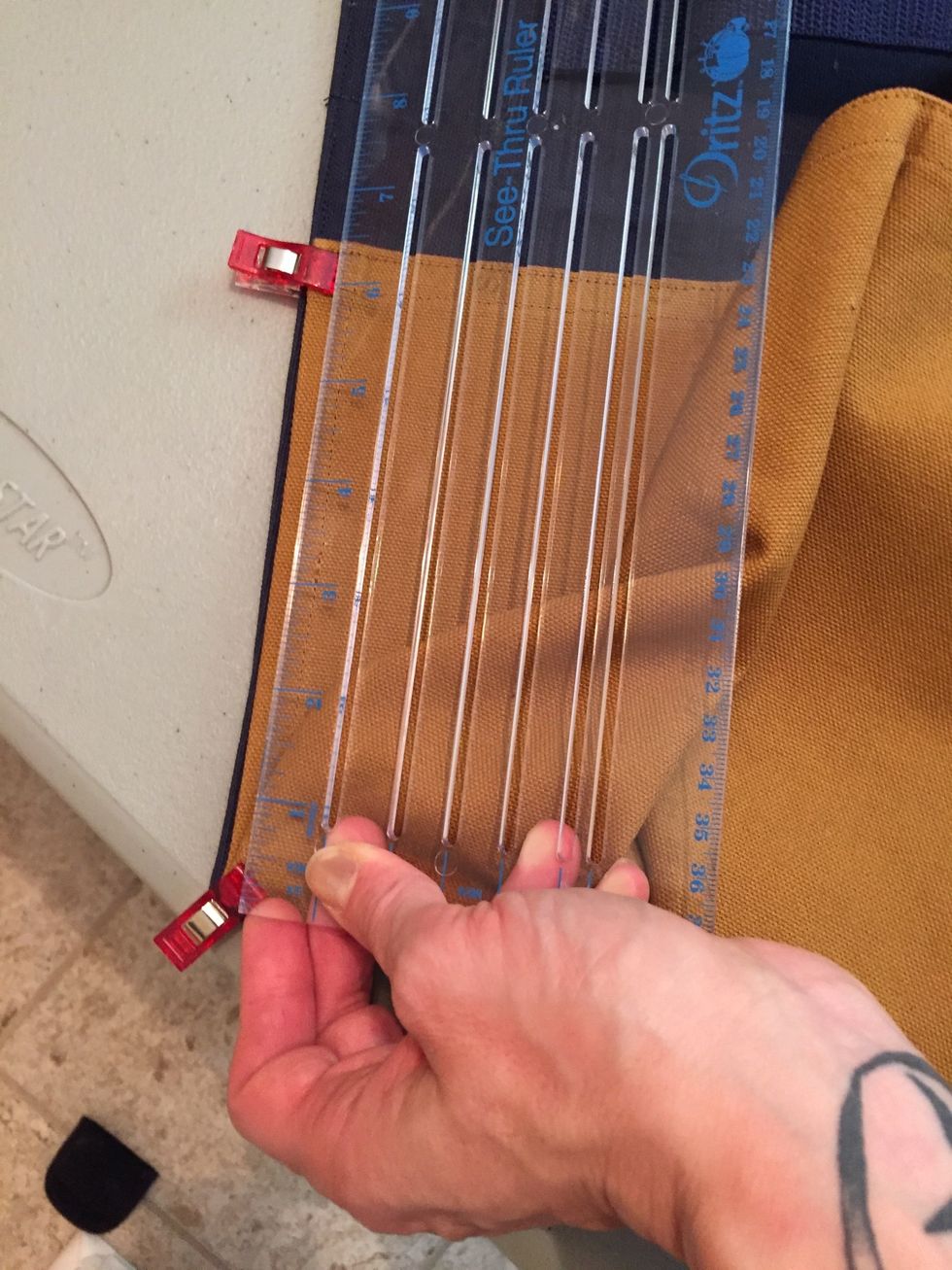 Pin bottle holder to body with top edge of bottle holder starting 6.5" from bottom corner of body.