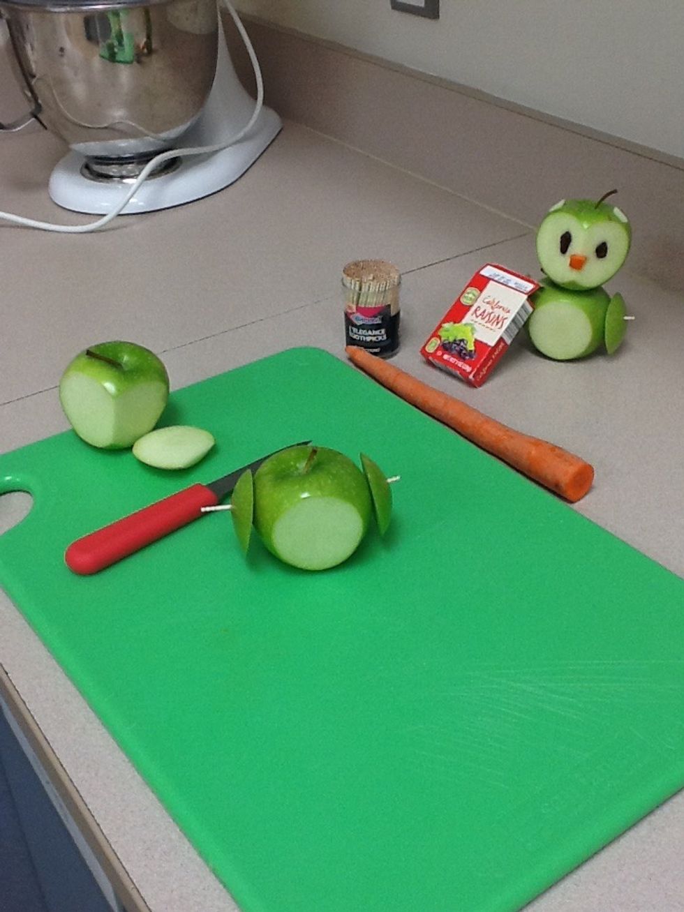 Pin one of the cut apple peels to the other part of the body to the apple with a tooth pick