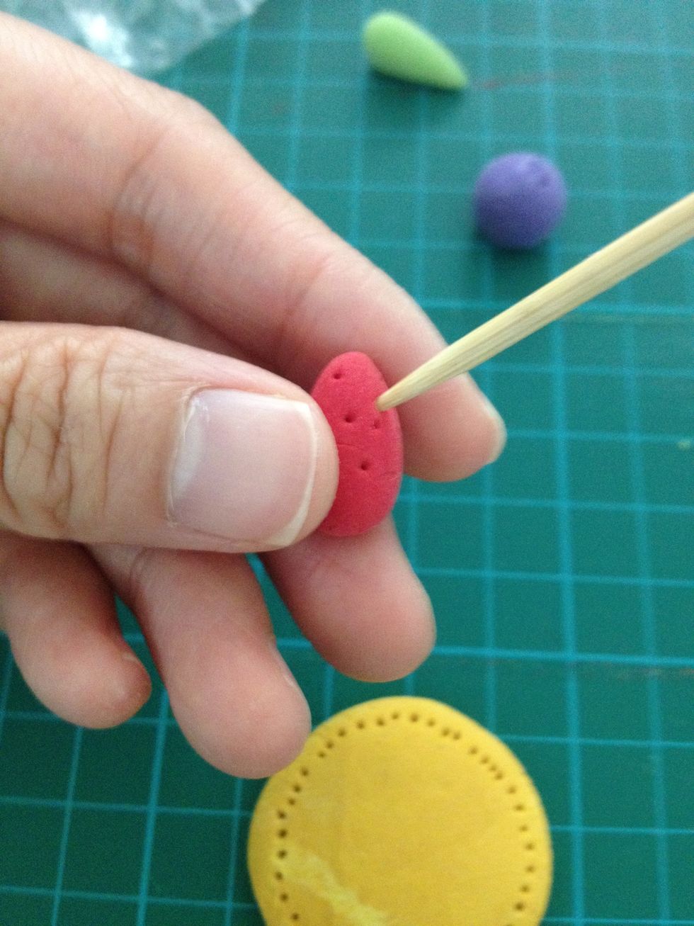 Pin some holes and make it become the strawberry.