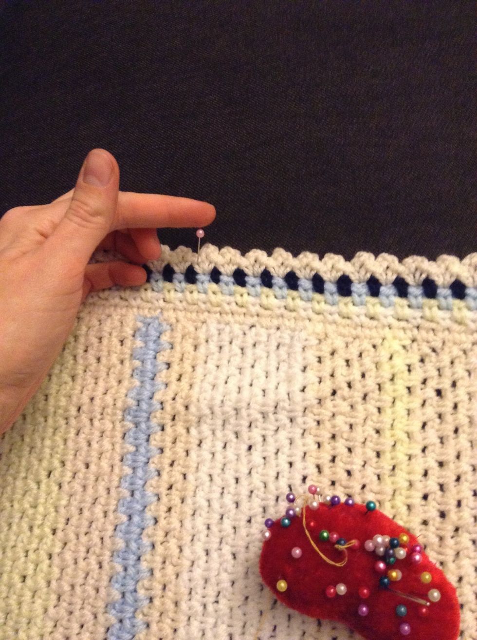 Pin the edges of the afghan all around stretching the afghan slightly.