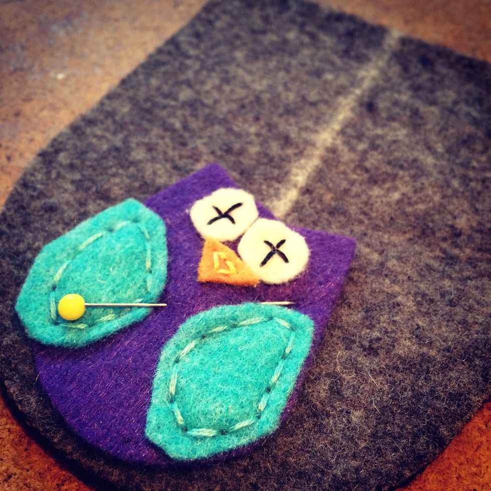 Pin the owl to the front of your booties and stitch them on. Notice I've added a chalk line for where I'll cut the opening of my booties. This helps with placing the owl.