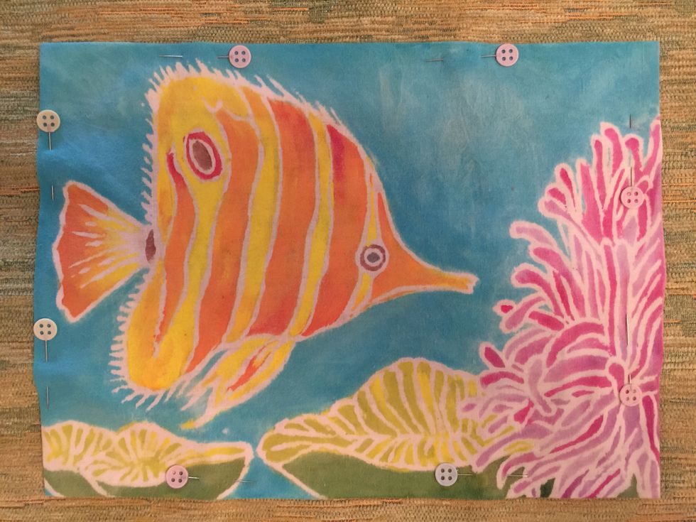 Pin the painted muslin to another piece of decorative fabric.