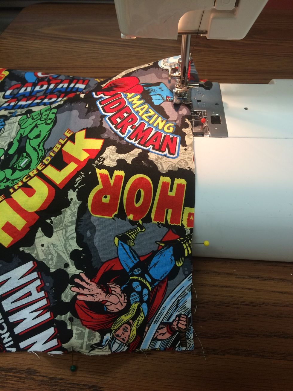 Pin then Stitch the pocket to the front piece along the 3 sides.