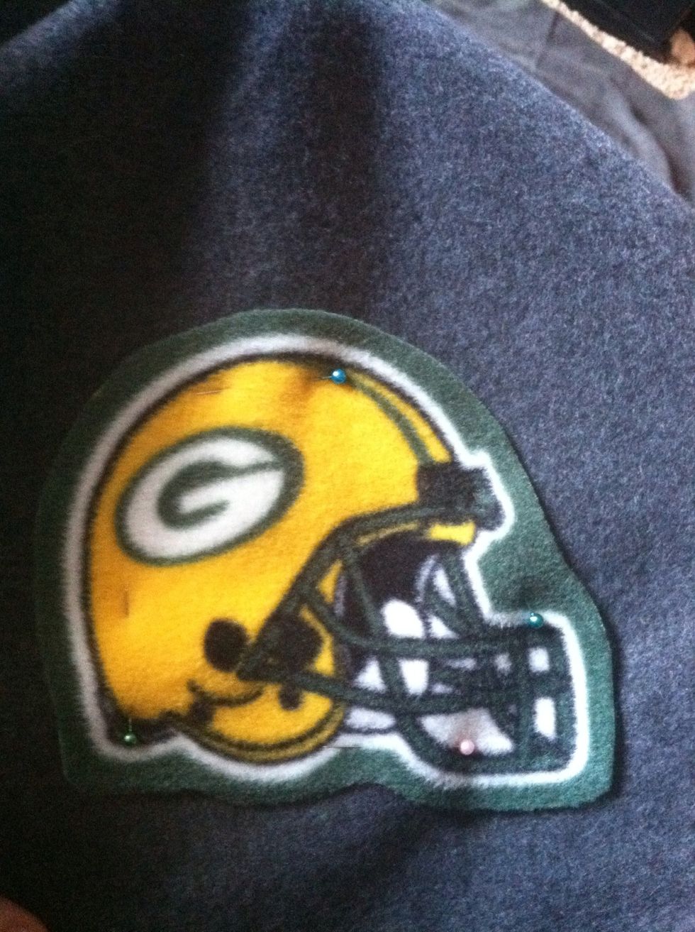 Pin your appliqu\u00e9 onto your base fabric.