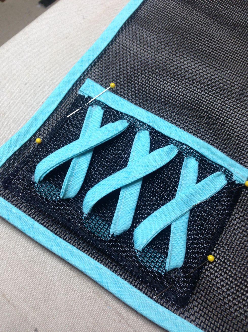 Pin your pocket to the bottom corner of each of your placemats.  Stitch down the two sides and across the bottom.