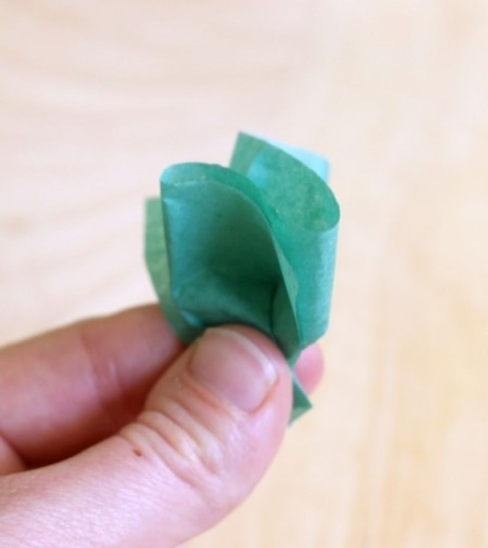 Pinch the bottom of the paper