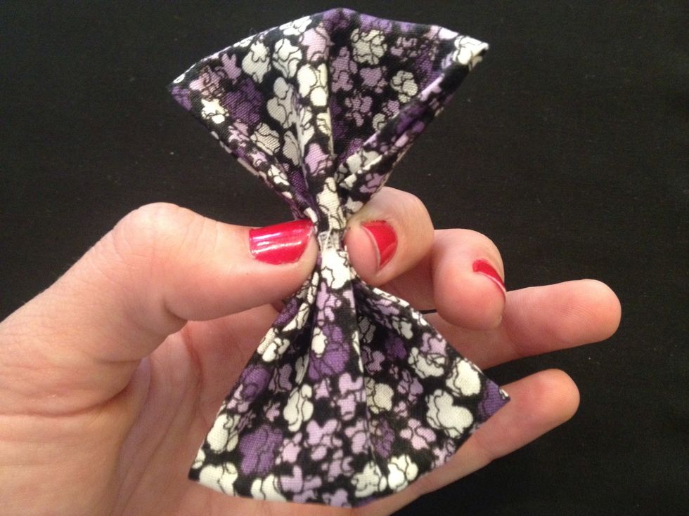 Pinch the fabric together in the middle to create the bow shape.