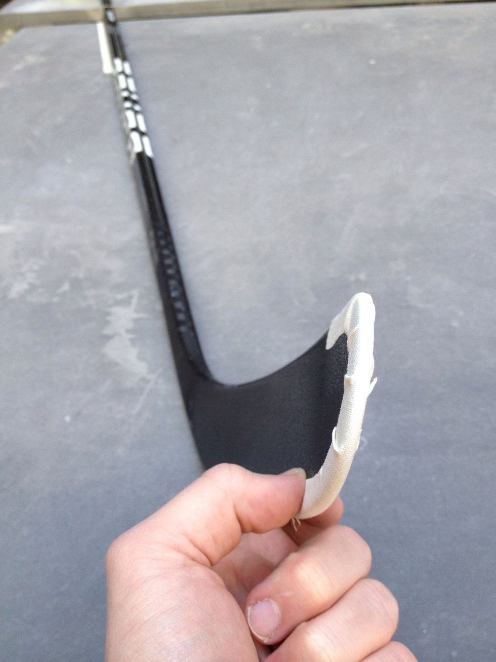 Pinch the tape down to front & back surfaces of the blade.