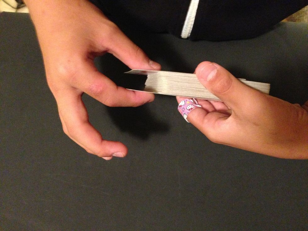 Pinch the top and the bottom cards and pull them off. Then place it on the top of the deck.