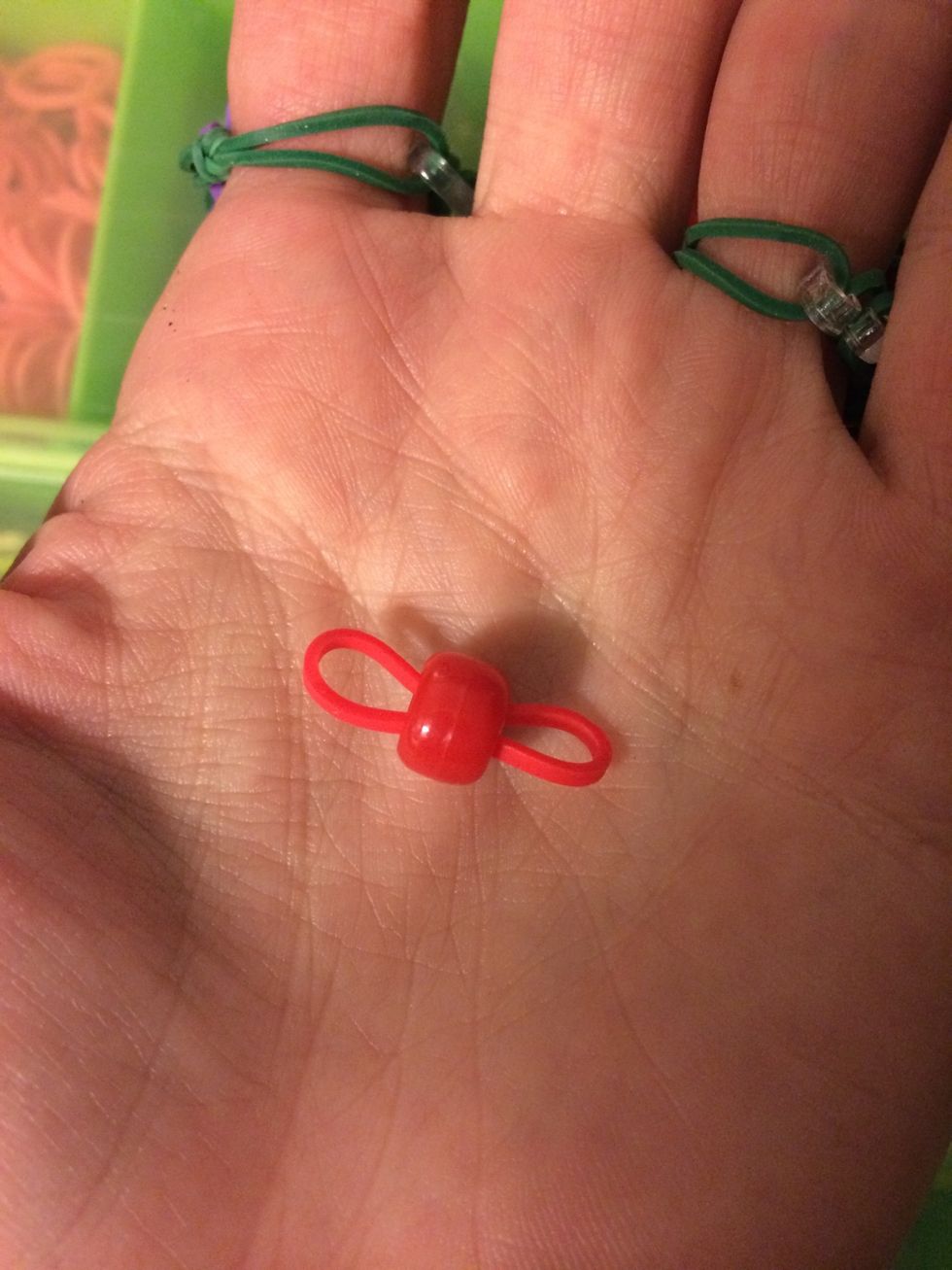 Pinch your band and put it through the pony bead