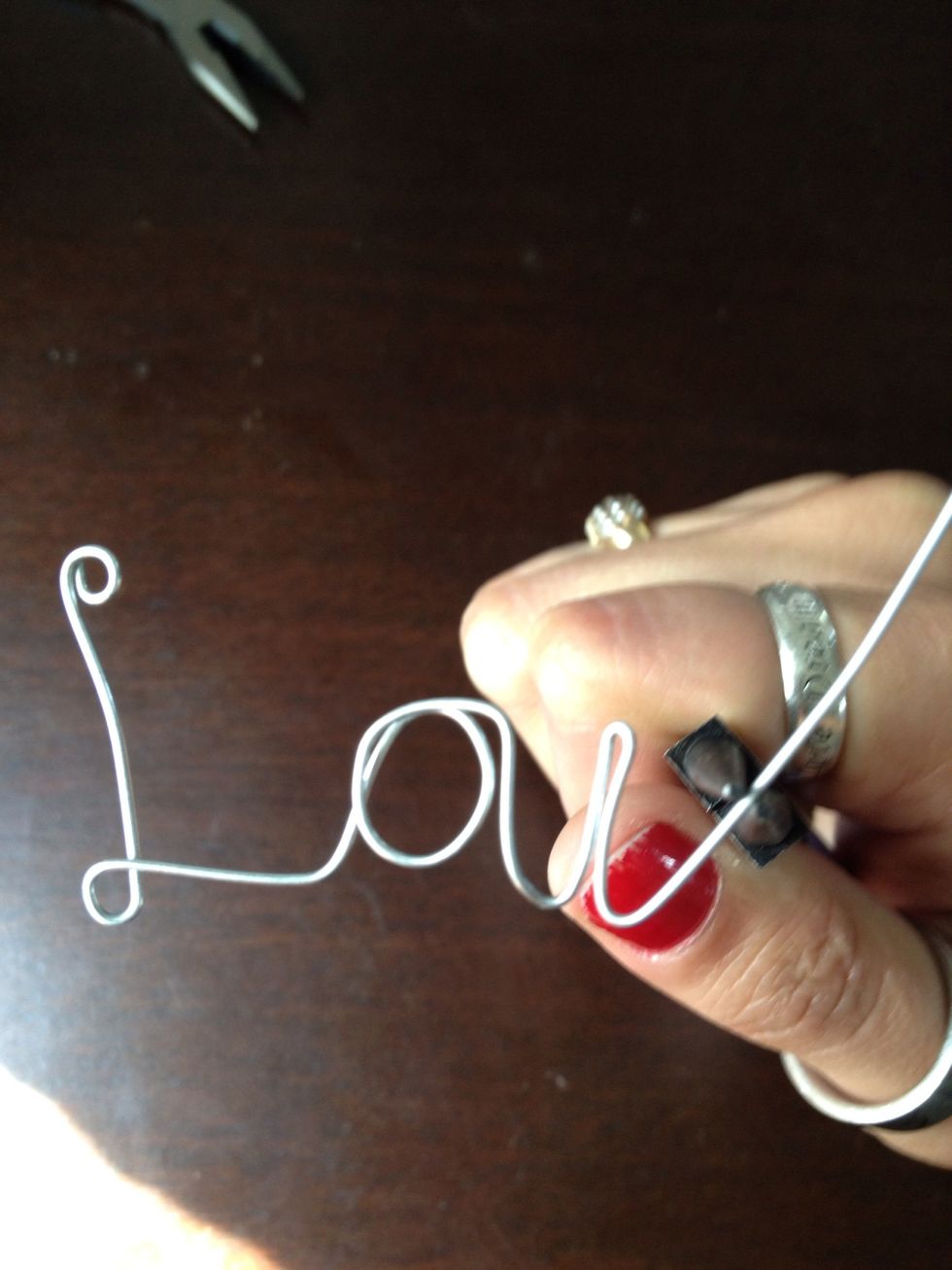 Pinching up a little on the wire release and curve the rest of the E.