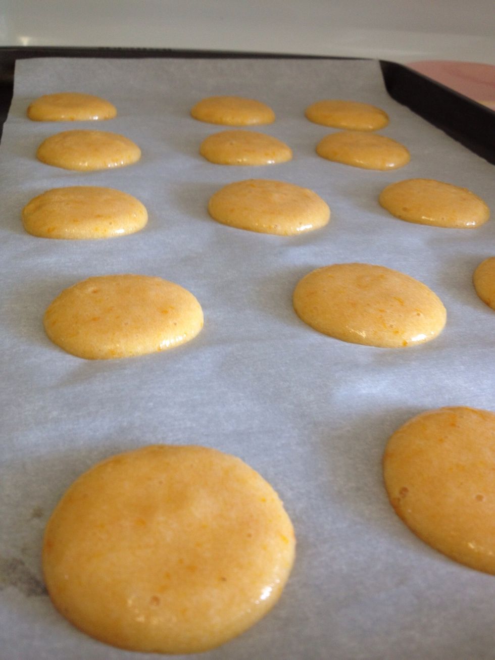 Pipe 1" circles onto parchment, leaving 1" between circles.  Tip: to get evenly sized circles, trace around a glass with a sharpie on the back of the parchment as a guide to fill.