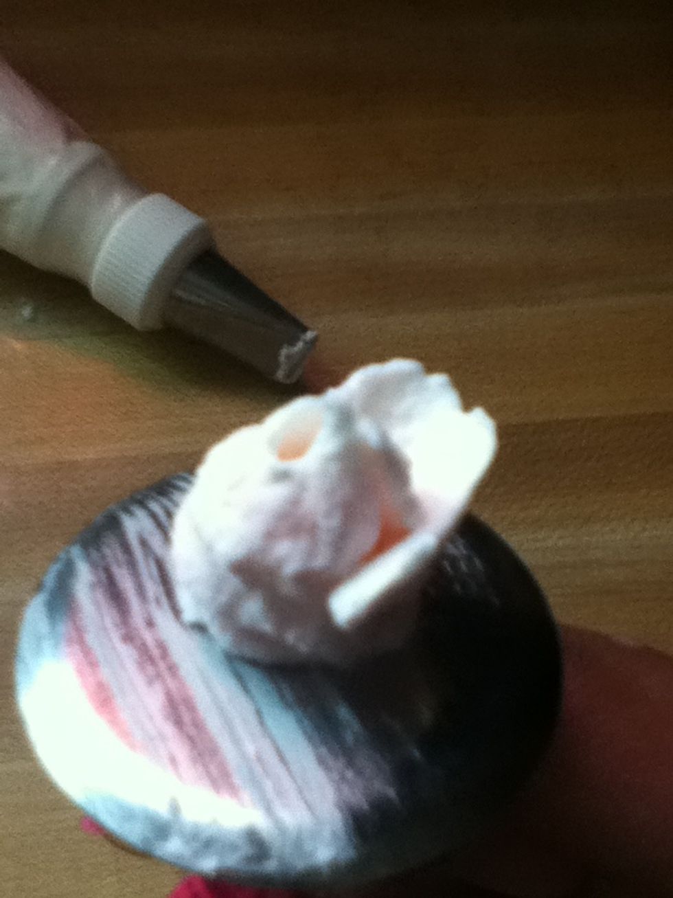 Pipe a petal by tilting ur piping bag at an 80* angle and pipe thee petals at the first row of petals then five petals in the second row and seven at the third row of petals