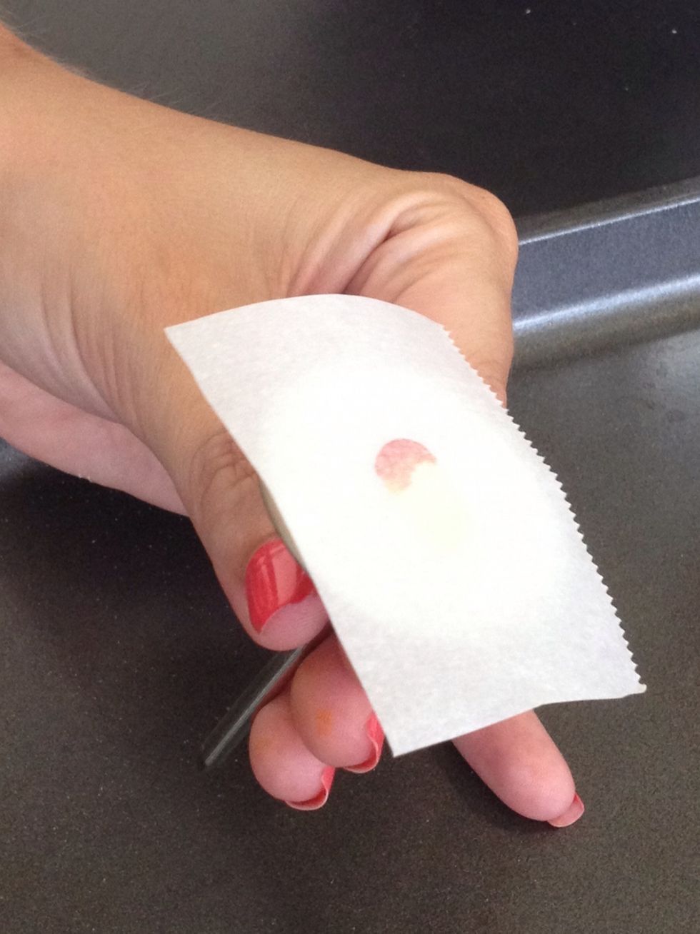 Pipe a small dot of buttercream on the flower nail. Use this to secure a square of wax paper on top of the nail.