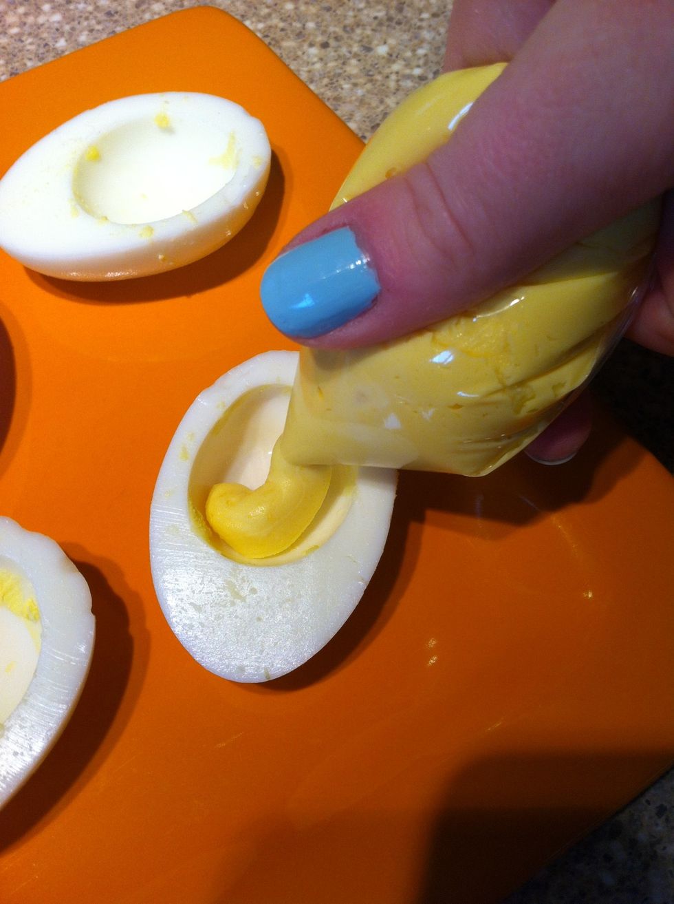 Pipe into eggs! (Or use a spoon) I find this a lot easier