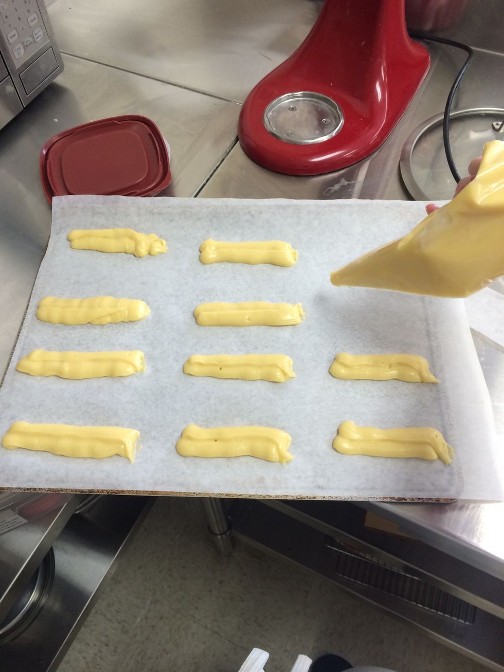 Pipe the dough into a parchment lined cookie sheet (about 4-5 inches long)