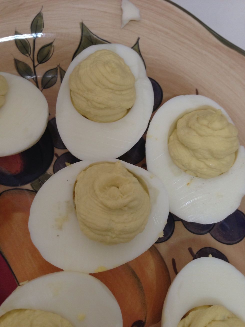 Pipe the egg mixture into the eggs. Clean up any spillage around the eggs to make them look neater.