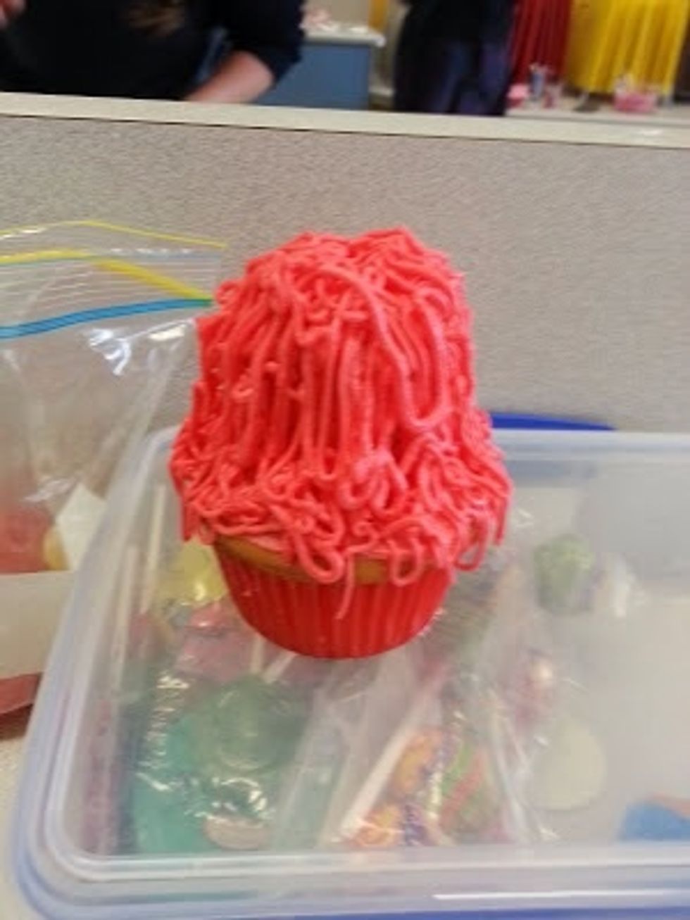 Pipe the icing over the cupcake in long squiggly lines