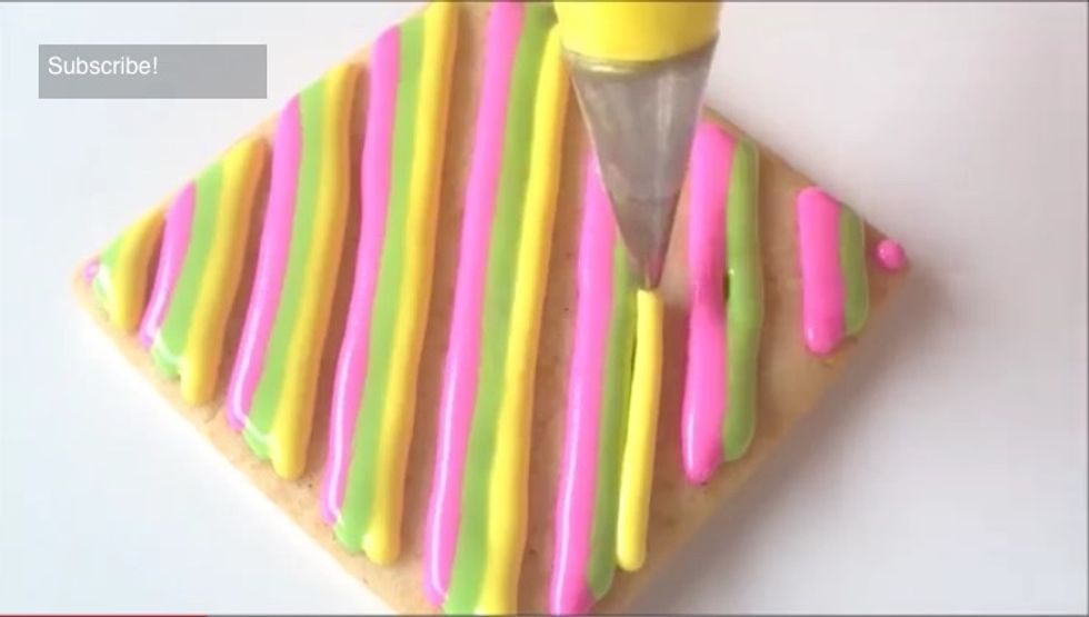 Pipe the third set of stripes on the cookie next to the second set of stripes.